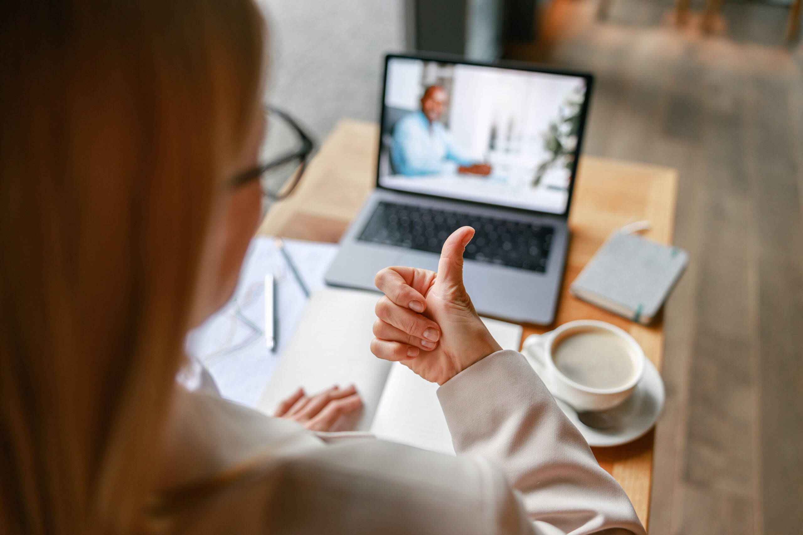 Businesswoman making videoconference and discuss project with colleague in cafe. High quality photo